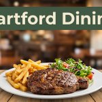 Grilled steak, fries, and salad on a wooden table in a warm Arkansas restaurant.