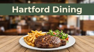 Grilled steak, fries, and salad on a wooden table in a warm Arkansas restaurant.