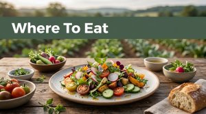 A seasonal farm-to-table meal on a wooden table with a blurred garden behind it.