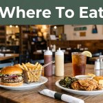 Southern dinner, burger, fries, and iced tea on a restaurant table with a green banner above.
