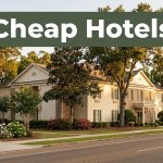 A warmly lit hotel exterior with trees and a dark-green Cheap Hotels banner.