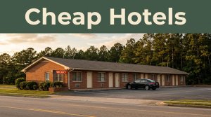 A modest roadside motel with a glowing vacancy sign during sunset.