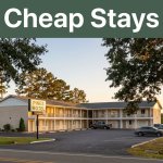 A warm roadside motel along a quiet rural Alabama highway during sunset.