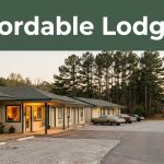 A rustic roadside motel at golden hour with a glowing office and pine trees.