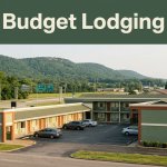 A modern roadside motel with parked cars near a highway and green hills.