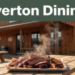 A rustic barbecue restaurant with a steaming platter on a picnic table.