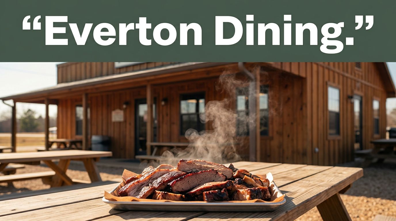 A rustic barbecue restaurant with a steaming platter on a picnic table.