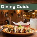 Tacos, rice, salsa, and a sparkling drink on a warmly lit restaurant table.