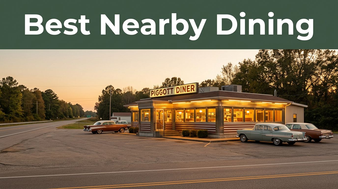 A warmly lit Arkansas diner beside a highway with classic cars at sunset.