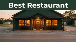 A Southern restaurant with glowing windows beside a quiet rural road at sunset.