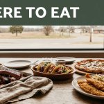 Tacos, pizza, catfish, and barbecue fill a warmly lit table beside an Arkansas road view.