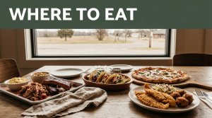 Tacos, pizza, catfish, and barbecue fill a warmly lit table beside an Arkansas road view.