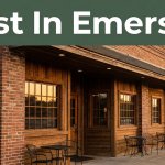 Rustic Arkansas steakhouse exterior with warm windows, outdoor seating, and a central entrance at sunset.