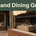 Small-town Arkansas restaurant with warm windows and a set table beneath a green dining guide banner.