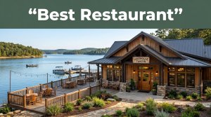 A rustic restaurant with warm windows, patio seating, and boats on calm lake water.