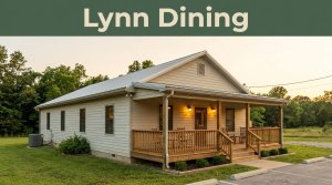 A small country restaurant with porch lights beneath a golden sky.