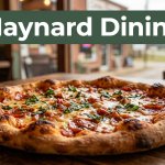 Fresh artisan pizza on a wooden table in a cozy Arkansas pizzeria.
