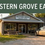 A small Arkansas grocery and deli beside a highway with a picnic table and parked vehicle.