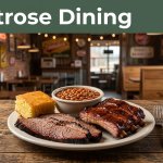 A barbecue platter with brisket, ribs, beans, and cornbread in a rustic restaurant.