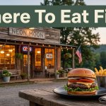 Burger and fries outside a warmly lit restaurant in Mountainburg, Arkansas.