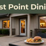 A cozy restaurant exterior with a burger and fries on a patio table.