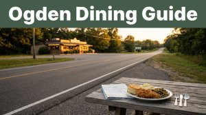 A comfort-food plate and road map overlook a highway leading to a lit diner at sunset.