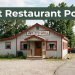 A rural diner with red-and-white accents and parked cars in warm morning light.