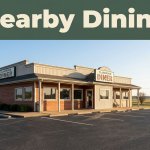 A small-town diner with a clean parking area, morning light, and Arkansas countryside beyond.