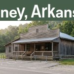 A rural Arkansas general store with a porch, parking area, and wooded hills.