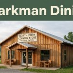 A rustic country store and eatery sits beside green countryside under a Sparkman Dining banner.