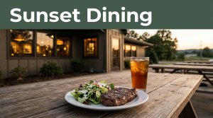 Grilled steak, salad, and iced tea outside a warmly lit Arkansas steakhouse at sunset.