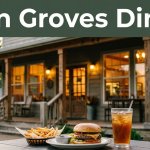 A rustic restaurant with a burger, fries, and iced tea on a table outside.