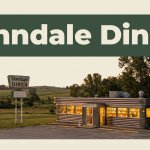 A small Arkansas diner with a roadside sign and glowing windows at sunset.