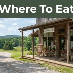 Charming Arkansas café beside a winding road with warm windows.