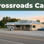 Crossroads Cafe sits beside a quiet rural highway in warm morning light.