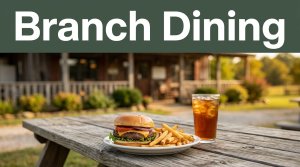 Burger, fries, and iced tea on a picnic table outside a rustic Arkansas grill.