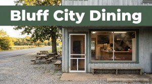 A rural barbecue storefront with picnic tables and a green Bluff City Dining banner.
