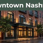 Boutique hotel facade on a downtown Nashville street beneath a dark-green Downtown Nashville banner.
