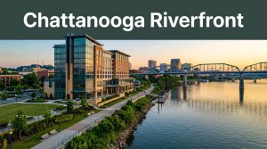 A modern Chattanooga hotel beside the Tennessee River with the skyline and Walnut Street Bridge behind it.