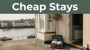 A guesthouse overlooks Bideford waterfront with a packed suitcase by the entrance.