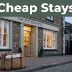 A welcoming Carmarthen hotel entrance with a suitcase and railway details in the background.