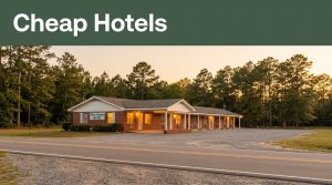 A modest motel glows beside a quiet Alabama road at sunset.