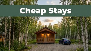 A cozy Fairbanks cabin hotel beside birch trees and a parked rental car at dusk.