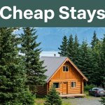 Rustic cabin among spruce trees with mountains, a rental car, and a Cheap Stays banner.