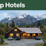A roadside lodge with parked cars beneath Alaska’s Lazy Mountain foothills.