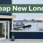 Budget hotel entrance with a suitcase and New London harbor in the background.