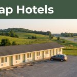 A quiet roadside motel with a parked car, green hills, and a Cheap Hotels banner.