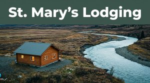 A wood lodge with lit windows beside the tundra and Andreafski River.