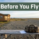 A packed bag and reservation sit outside a cabin near a gravel airstrip in Toksook Bay.