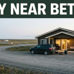 A small Bethel motel entrance beside a gravel road and tundra.